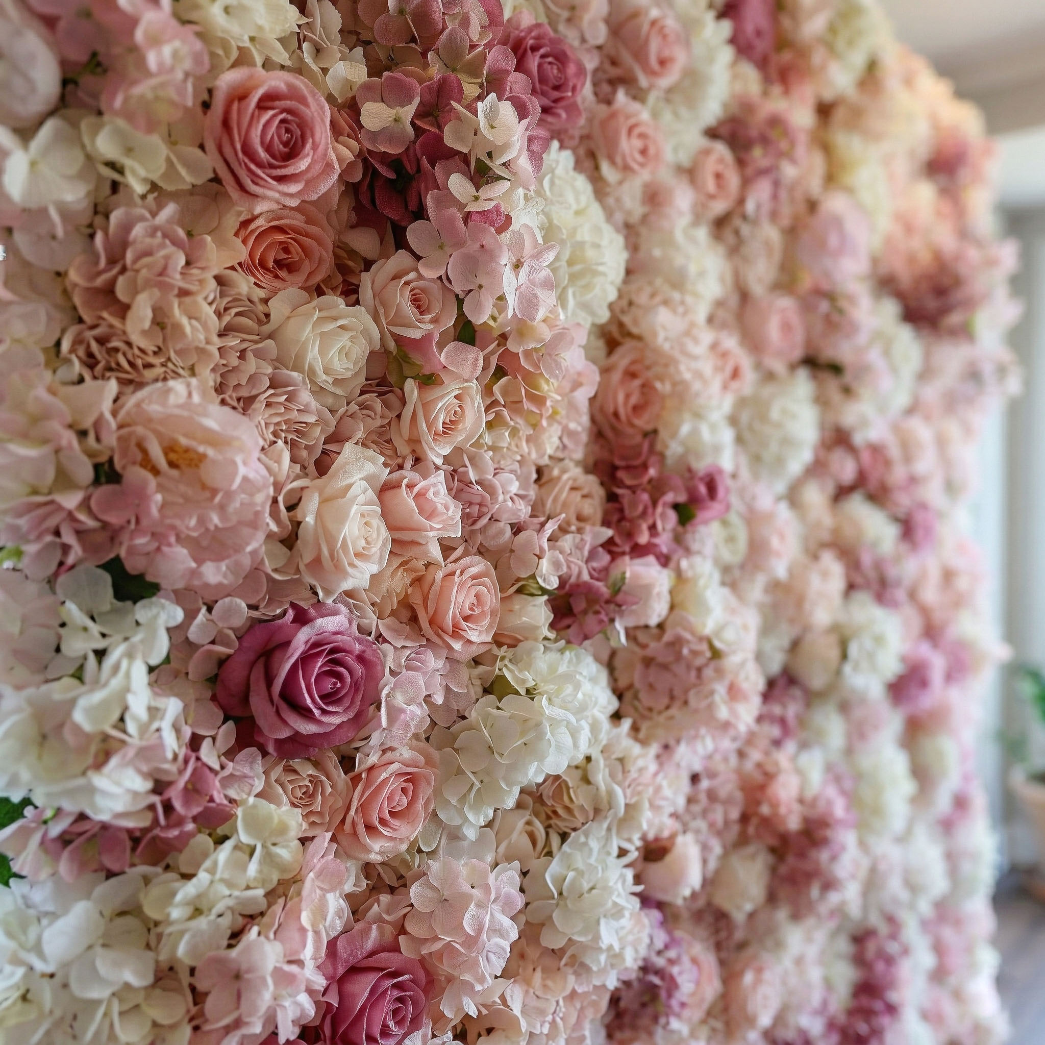 Close-up of blush and dusty rose Real Touch roses with ivory hydrangea