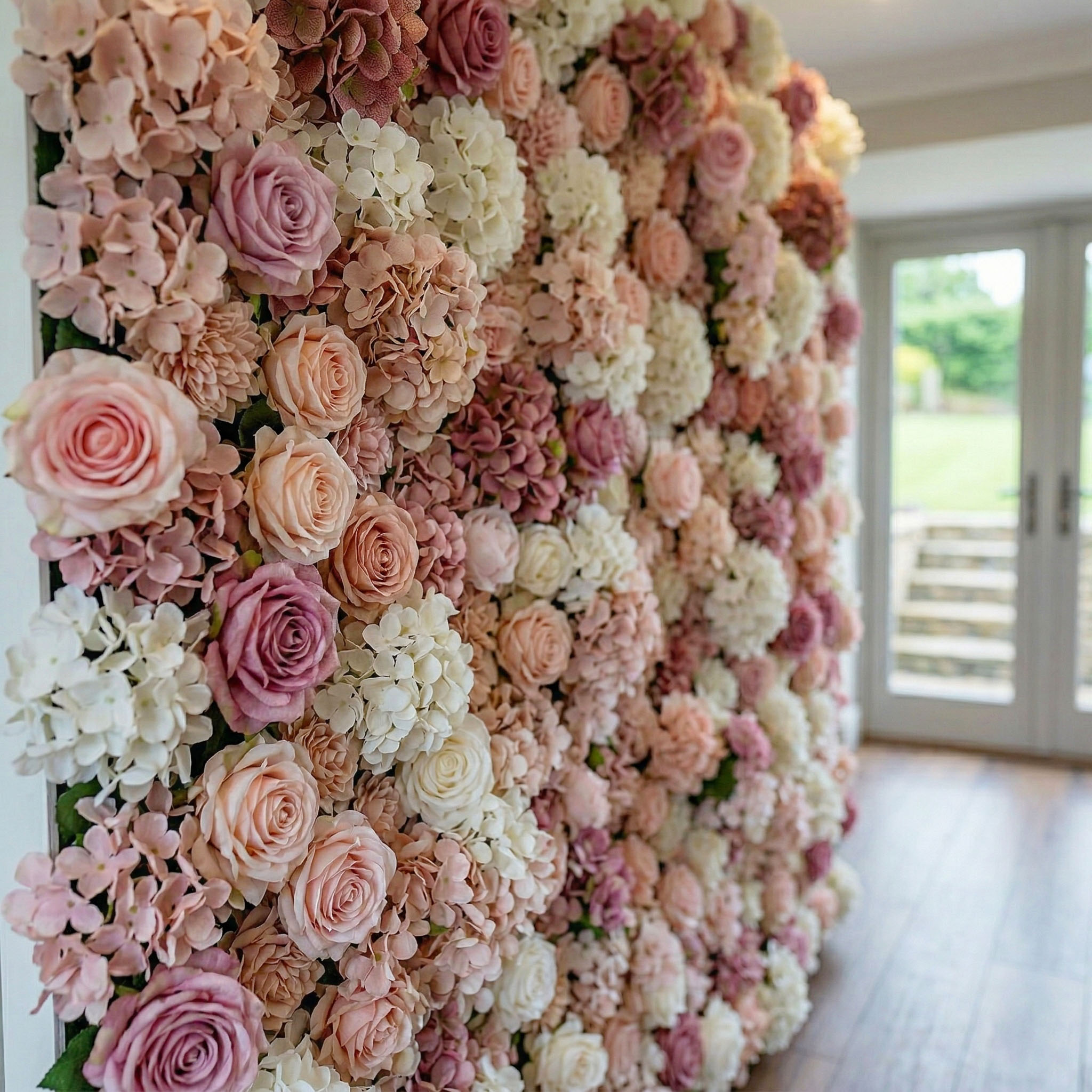 Pink and white flower wall with mauve roses and baby's breath accents